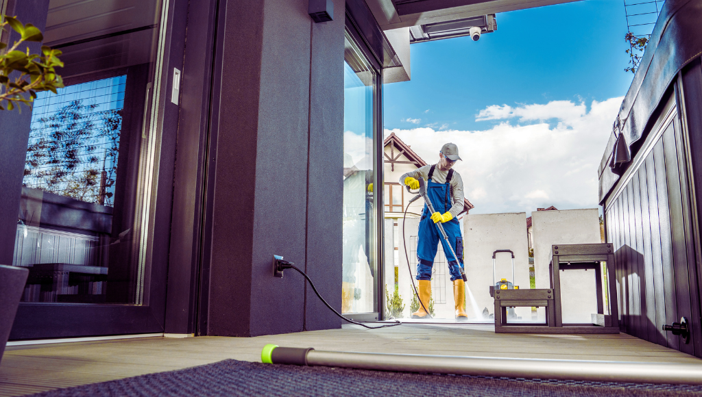 Homeowner pressure washing a patio